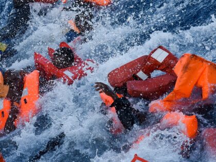 Migrants and refugees panic as they fall in the water during a rescue operation of the Topaz Responder rescue ship run by Maltese NGO Moas and Italian Red Cross, off the Libyan coast in the Mediterranean Sea, on November 3, 2016. (Photo by ANDREAS SOLARO / AFP) (Photo by ANDREAS …