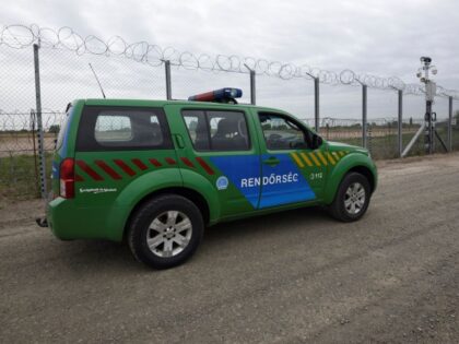(----EDITORIAL USE ONLY MANDATORY CREDIT - "HUNGARIAN INTERIOR MINISTRY PRESS OFFICE / HANDOUT" - NO MARKETING NO ADVERTISING CAMPAIGNS - DISTRIBUTED AS A SERVICE TO CLIENTS----) ROSZKE, HUNGARY - APRIL 28 : A police car patrols along the border fence on the Hungarian-Serbian border near Roszke, 180 kms southeast of …