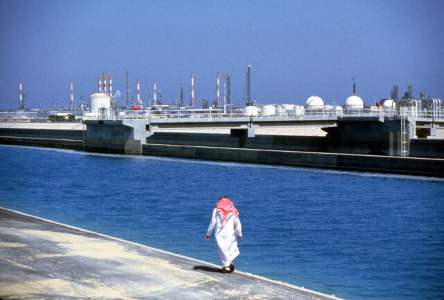 075847 01: A citizen walks along a waterfront oil refinery plant December 10, 1987 in Saud