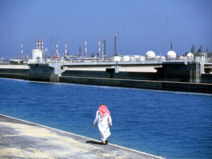 075847 01: A citizen walks along a waterfront oil refinery plant December 10, 1987 in Saud