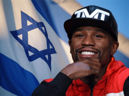 WBC/WBA welterweight champion Floyd Mayweather Jr. smiles during a news conference at the