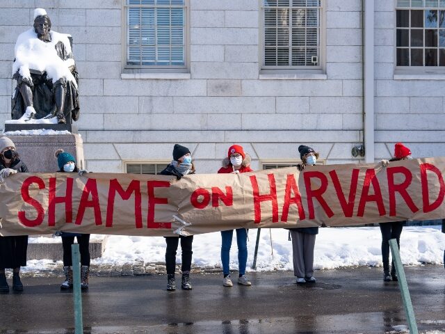 Demonstrators hold a banner during a 'No Justice Walkout' protest at Harvard Uni