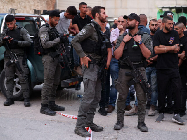 sraeli security forces and onlookers gather in front of a car wash, where five Arab Israel