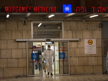 A medical professional in protective gear leaves the emergency department at Hadassah Medi