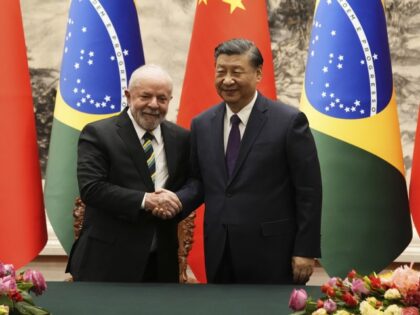 Brazilian President Luiz Inacio Lula da Silva, left, shakes hands with Chinese President X