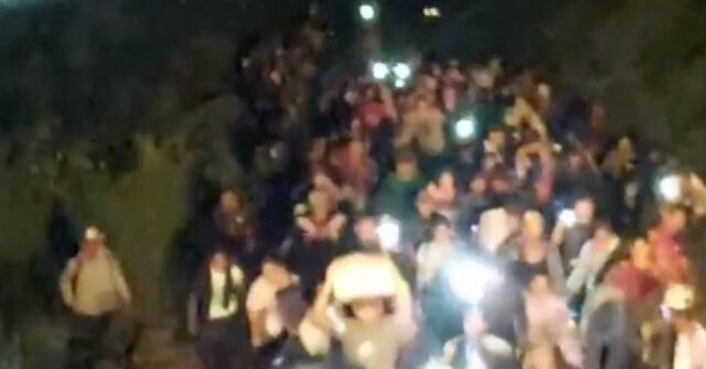 Photos: Migrants Swarm Mexican Railroad, Force Train to Stop