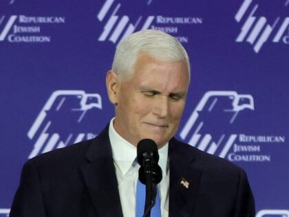 Republican presidential candidate former U.S. Vice President Mike Pence reacts after suspe