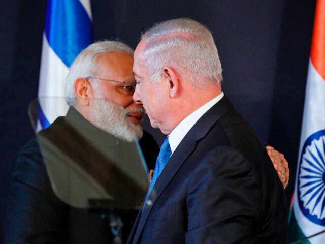 Indian Prime Minister Narendra Modi (L) shakes hands with his Israeli counterpart Benjamin
