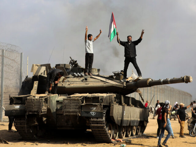 Palestinians Celebrate on Destroyed Israeli Tank 1