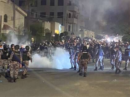 Jordanian security forces fire tear gas against demonstrators attempting to storm the Isra