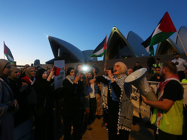 SYDNEY, AUSTRALIA - OCTOBER 09: Palestine supporters rally outside the Sydney Opera House on October 09, 2023 in Sydney, Australia. The Palestinian militant group Hamas launched a surprise attack on Israel from Gaza by land, sea, and air, over the weekend, killing over 600 people and wounding more than 2000, …