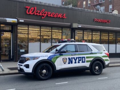 NYPD police car parked outside Walgreens Pharmacy responding to shoplifting call, Queens,