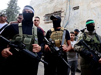 Palestinian militants stand guard during the funeral of 19-year-old Ahmad Awawda who was killed the previous day in clashes with Israeli troops, in the occupied West Bank Jenin on October 8, 2023. Following the latest Hamas offensive and Israeli reprisals on the Gaza Strip, clashes flared on October 7 across …