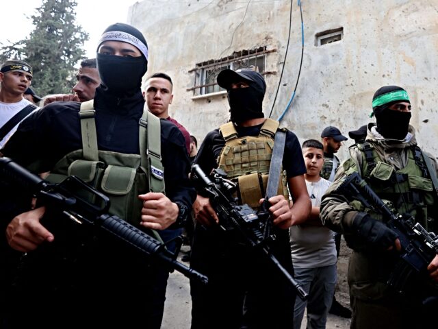 Palestinian militants stand guard during the funeral of 19-year-old Ahmad Awawda who was k
