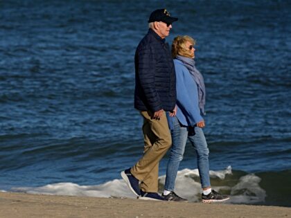 US President Joe Biden and First Lady Jill Biden walk on the beach in Rehoboth Beach, Dela