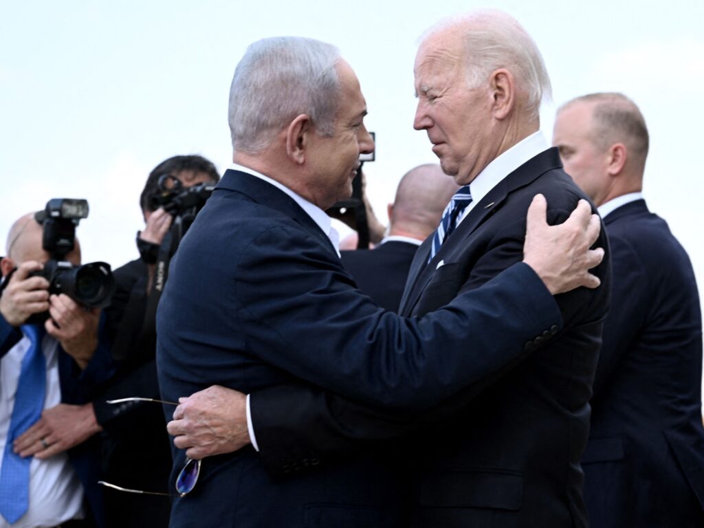 TOPSHOT - Israel Prime Minister Benjamin Netanyahu (L) greets US President Joe Biden upon his arrival at Tel Aviv's Ben Gurion airport on October 18, 2023, amid the ongoing battles between Israel and the Palestinian group Hamas. Biden landed in Israel on October 18, on a solidarity visit following Hamas attacks that have led to major Israeli reprisals. Thousands of people, both Israeli and Palestinians have died since October 7, 2023, after Palestinian Hamas militants based in the Gaza Strip, entered southern Israel in a surprise attack leading Israel to declare war on Hamas in Gaza on October 8. (Photo by Brendan SMIALOWSKI / AFP) (Photo by BRENDAN SMIALOWSKI/AFP via Getty Images)