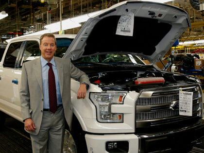 Bill Ford, executive chairman of Ford Motor Co., stands for a photograph with a 2015 Ford