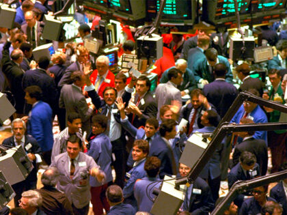 Traders on the floor of the New York Stock Exchange work frantically as the Dow Jones Indu