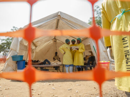 Medical staff give treatment to people suffering from cholera at a medical camp set up out