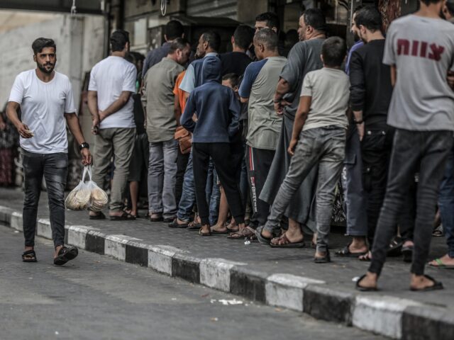 GAZA CITY, GAZA - OCTOBER 17: Palestinians wait in line to shop after Israeli authorities