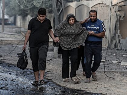 GAZA CITY, GAZA - OCTOBER 16: Palestinians carrying belongings flee to safer areas followi