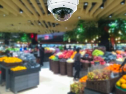 CCTV camera security in shopping mall with supermarket blur background.