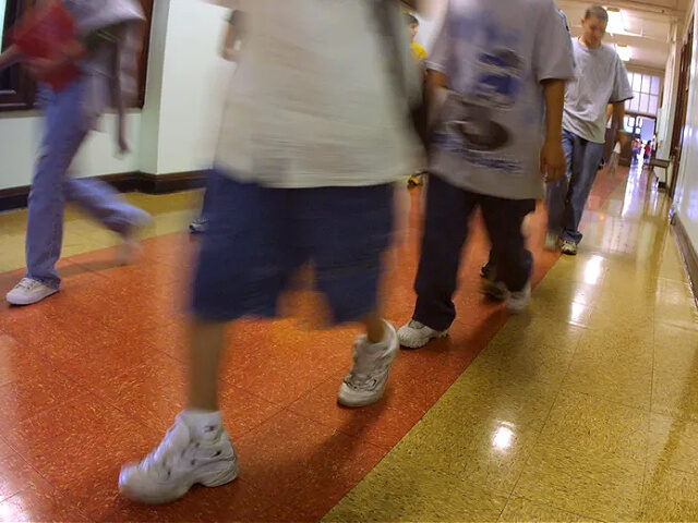 391429 07: Students hustle through a hallway between classes during summer school July 3,