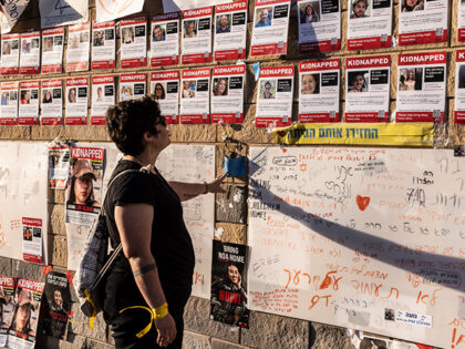 TEL AVIV , ISRAEL- OCTOBER 21:Tal Shlomo ,29 ,as she reaches out to touch one the posters