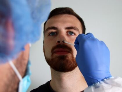 A man receives a nasal swab test.