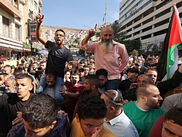 Palestinians in the West Bank city of Nablus celebrate on October 7, 2023, after fighters from the Gaza Strip infiltrated Israel, a major escalation in the Israeli-Palestinian conflict. (Photo by Jaafar ASHTIYEH / AFP) (Photo by JAAFAR ASHTIYEH/AFP via Getty Images)
