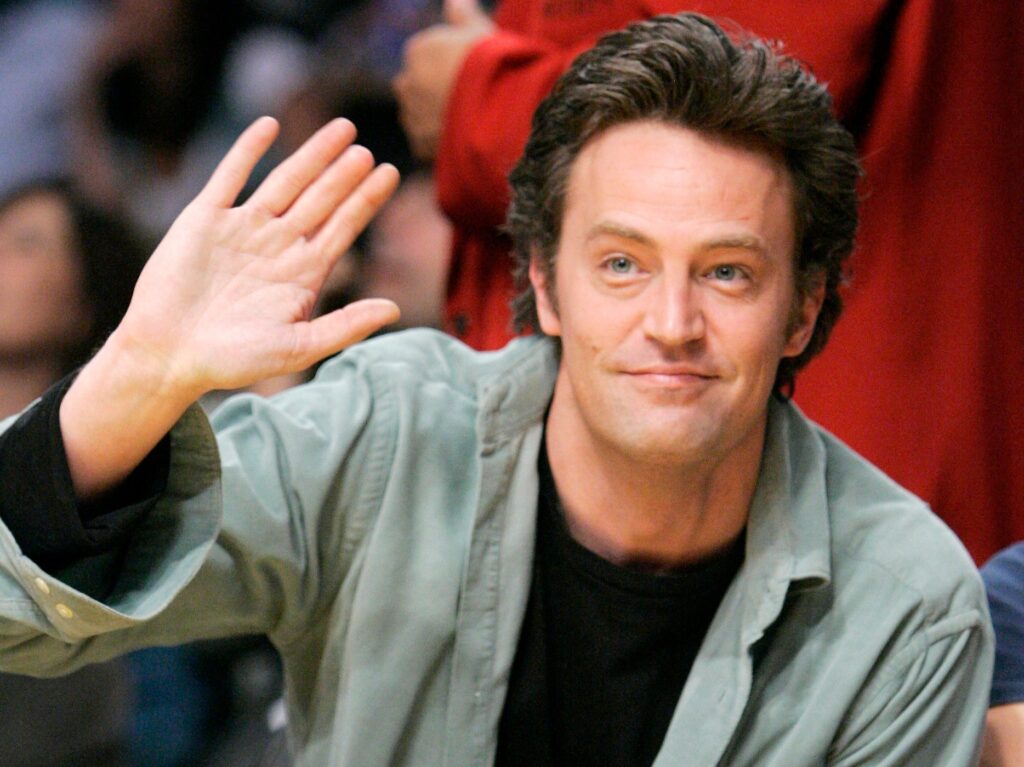 Actor Matthew Perry waves as he watches the Los Angeles Lakers play the Seattle SuperSonics in their NBA basketball game, Friday night, Nov. 3, 2006, in Los Angeles. (AP Photo/Mark J. Terrill)