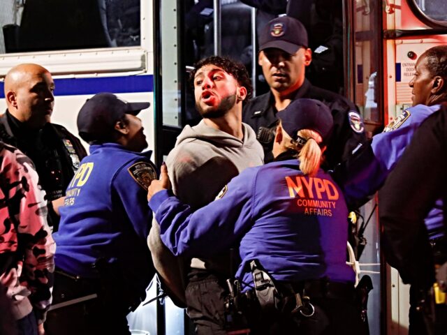 A man is arrested by police officers after protesters clashed with members of the New York
