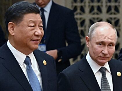 This pool photograph distributed by Russian state owned agency Sputnik shows Russia's President Vladimir Putin (R) and China's President Xi Jinping heading to a group photo session during the third Belt and Road Forum for International Cooperation at the Great Hall of the People in Beijing on October 18, 2023. …