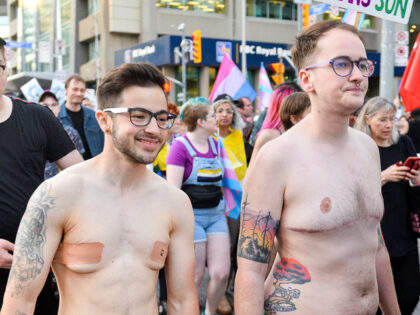 STREET, TORONTO, ONTARIO, CANADA - 2019/06/21: A naked protester smiles during the Trans m