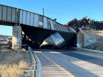 This image provided by the Colorado State Patrol shows a truck caught under a bridge that