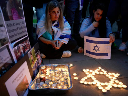 People light candles during the 'Jewish Community Vigil' for Israel in London, Monday, Oct
