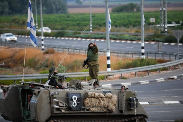 An armored Israeli vehicle is seen near the border with Lebanon on October 15, 2023