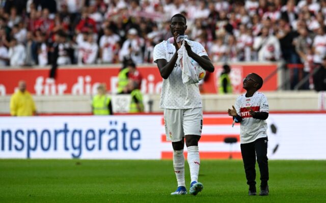Bundesliga history maker Serhou Guirassy celebrates with his son after Stuttgart defeated
