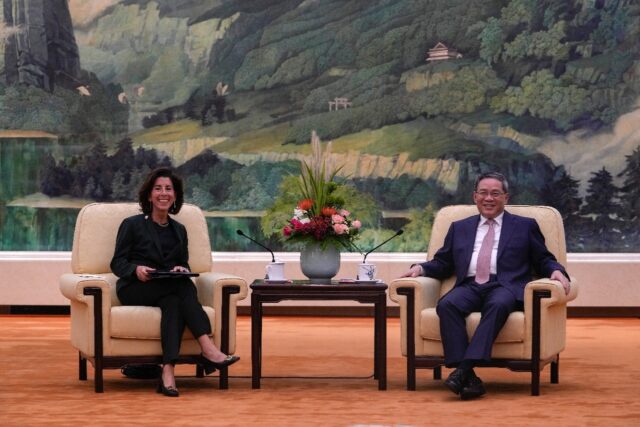 China's Premier Li Qiang (R) speaks with US Commerce Secretary Gina Raimondo in Beijing in