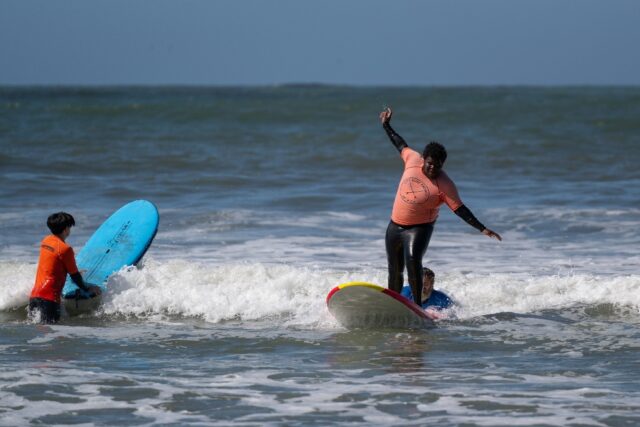 Damiane Fisher, 18, catches a wave off the California coast
