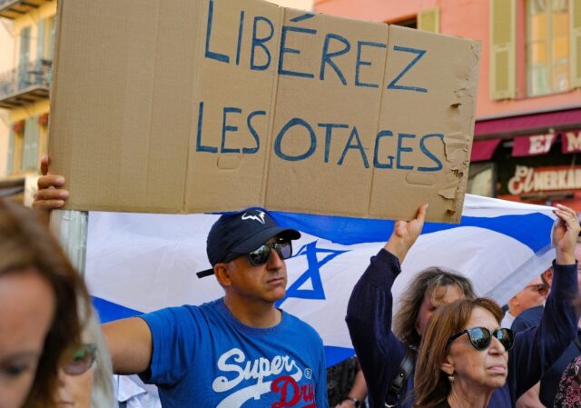 A demonstrator holds a placard reading "Free the hostages" during a rally in support of th