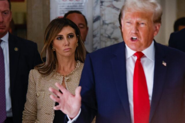 Donald Trump's lawyer Alina Habba listens as the former president addresses the media duri