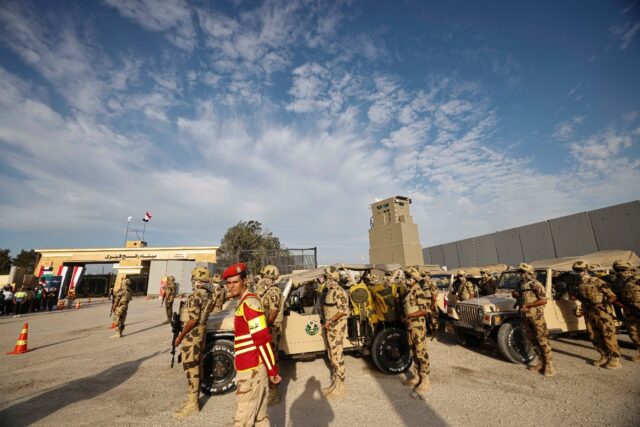 Egyptian soldiers stand guard during a visit by Prime Minister Mostafa Madbouli to the Raf