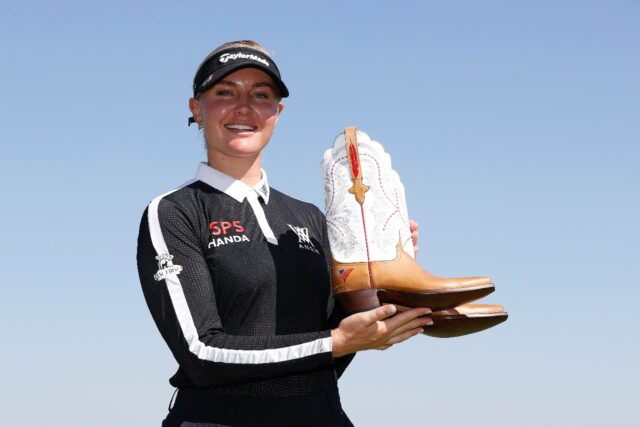 England's Charley Hull poses with a pair of custom cowboy boots after winning the 2022 Asc