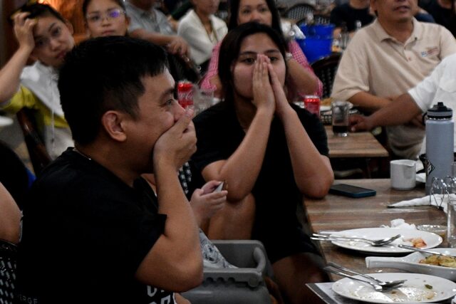 Filipinos celebrate their team's gold medal victory in the men's basketball final at the A