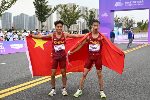 Gold medallist He Jie (L) and bronze medallist Yang Shaohui celebrate