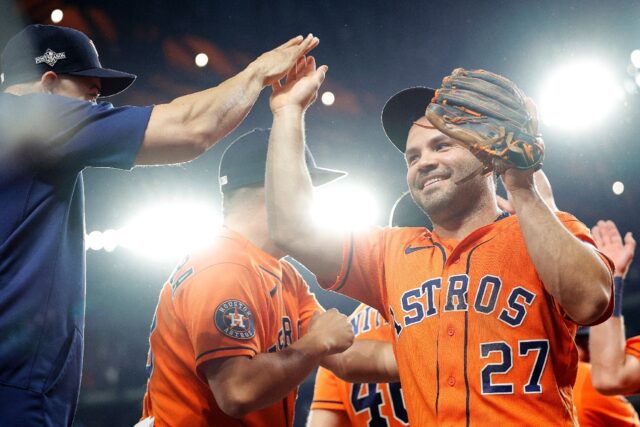 Houston's Jose Altuve, right, celebrates with teammates after hitting a three-run homer th