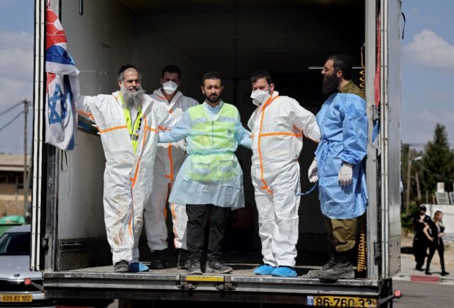 Hundreds of bodies waiting to be identified or to be taken for burial are stored in contai