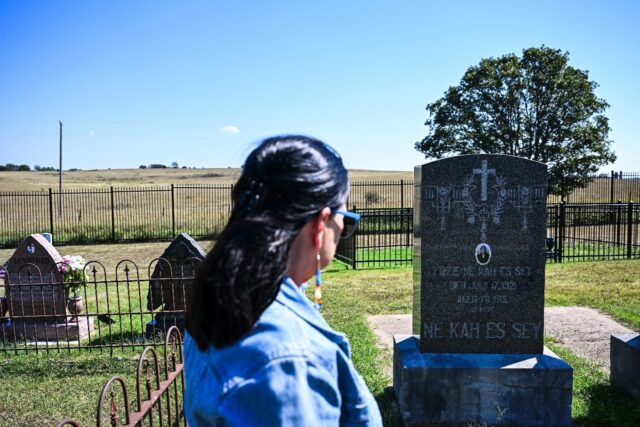Margie Burkhart visits the cemetery where her murdered ancestors are buried in Gray Horse,