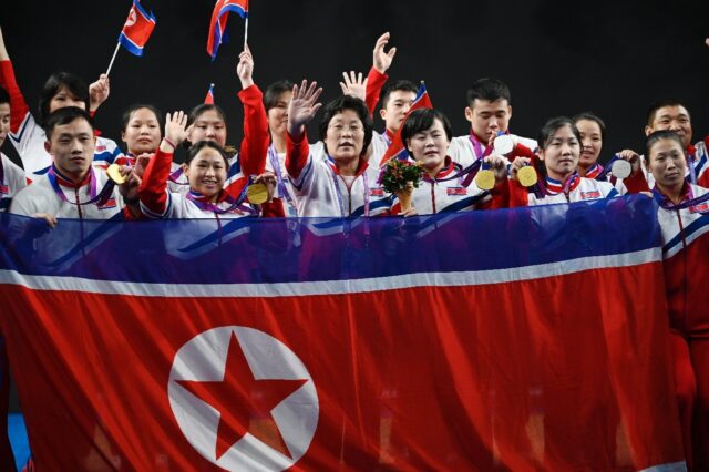 North Korea's weightlifting team show off their Asian Games medals at at the Hangzhou Spor